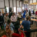 Attendees networking inside a rustic venue during the Invest Rural event in Bathurst, discussing rural innovation and startup growth