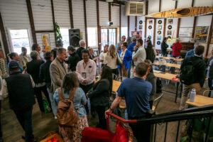 Attendees networking inside a rustic venue during the Invest Rural event in Bathurst, discussing rural innovation and startup growth