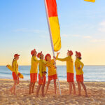 Surf Life Savers Putting up Red & Yellow Flags